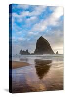 Haystack Rock reflected on the shoreline at Cannon Beach on the Pacific Northwest coast, Oregon, Un-Martin Child-Stretched Canvas