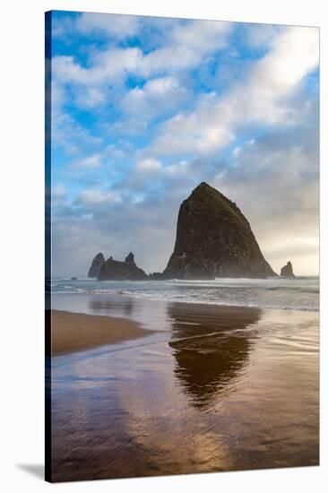 Haystack Rock reflected on the shoreline at Cannon Beach on the Pacific Northwest coast, Oregon, Un-Martin Child-Stretched Canvas