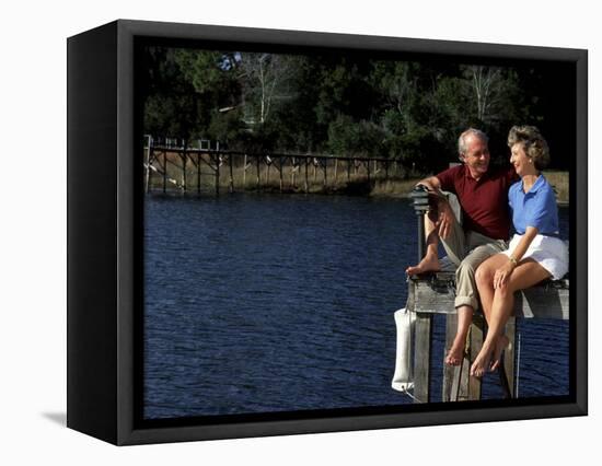 Healthy Couple Sitting on the Dock by a Lake-Bill Bachmann-Framed Stretched Canvas