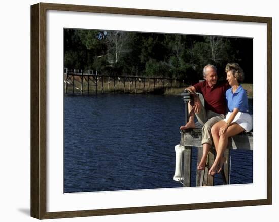 Healthy Couple Sitting on the Dock by a Lake-Bill Bachmann-Framed Photographic Print