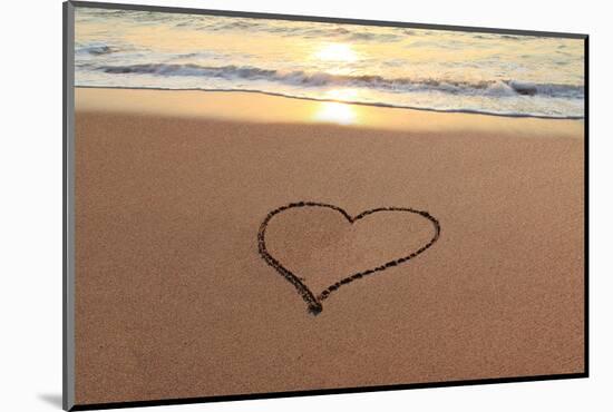 Heart in the Sand on the Beach at Sunset.-Hannamariah-Mounted Photographic Print