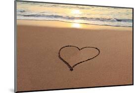 Heart in the Sand on the Beach at Sunset.-Hannamariah-Mounted Photographic Print