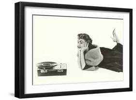 Heavily Browed Lady Listening to Record Player-null-Framed Art Print
