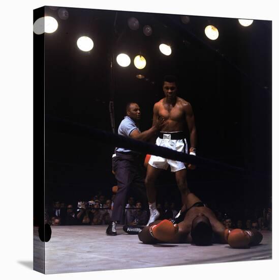 Heavyweight Boxer Cassius Clay, aka Muhammad Ali, Standing over Opponent Sonny Liston-George Silk-Stretched Canvas