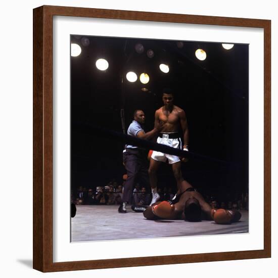 Heavyweight Boxer Cassius Clay, aka Muhammad Ali, Standing over Opponent Sonny Liston-George Silk-Framed Premium Photographic Print