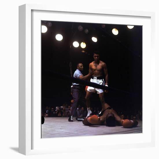 Heavyweight Boxer Cassius Clay, aka Muhammad Ali, Standing over Opponent Sonny Liston-George Silk-Framed Premium Photographic Print