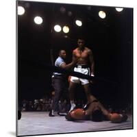 Heavyweight Boxer Cassius Clay, aka Muhammad Ali, Standing over Opponent Sonny Liston-George Silk-Mounted Premium Photographic Print