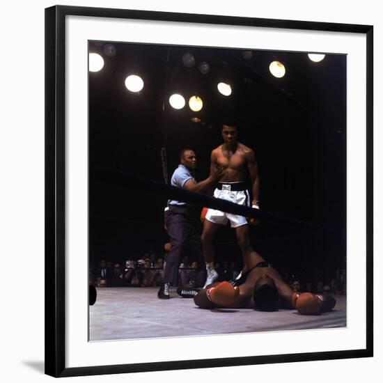 Heavyweight Boxer Cassius Clay, aka Muhammad Ali, Standing over Opponent Sonny Liston-George Silk-Framed Premium Photographic Print