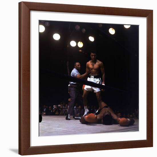 Heavyweight Boxer Cassius Clay, aka Muhammad Ali, Standing over Opponent Sonny Liston-George Silk-Framed Premium Photographic Print