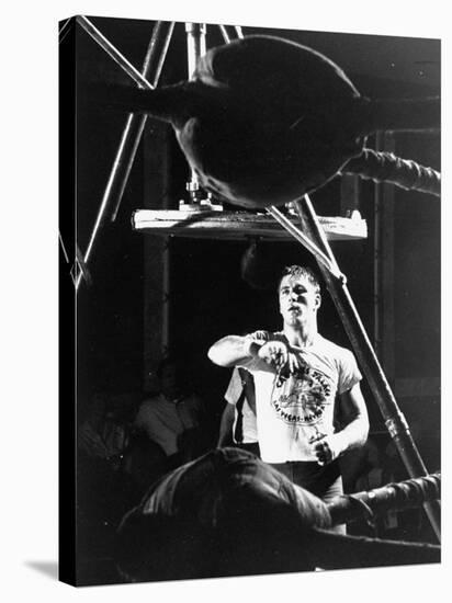 Heavyweight Boxing Contender Jerry Quarry Working Out on Punching Bag, Training at Caesar's Palace-Richard Meek-Stretched Canvas
