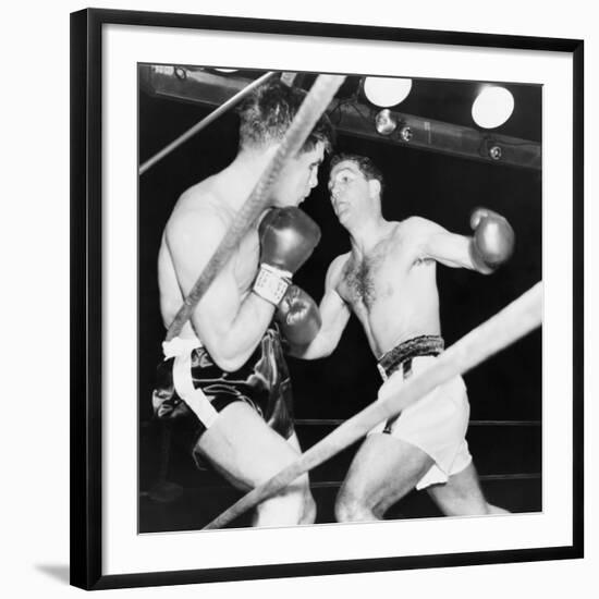 Heavyweight Champion Rocky Marciano (Right) Backs Roland Lastarza Against the Ropes-null-Framed Photo