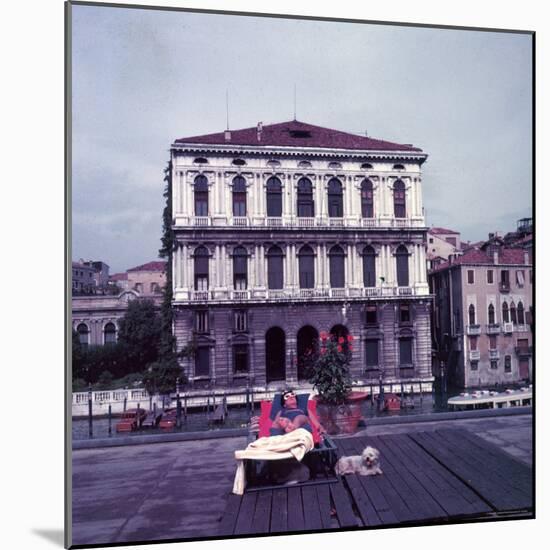 Heiress Peggy Guggenheim Sunbathing on Terrace of Venier Dei Leoni Palace on Grand Canal in Venice-Frank Scherschel-Mounted Premium Photographic Print