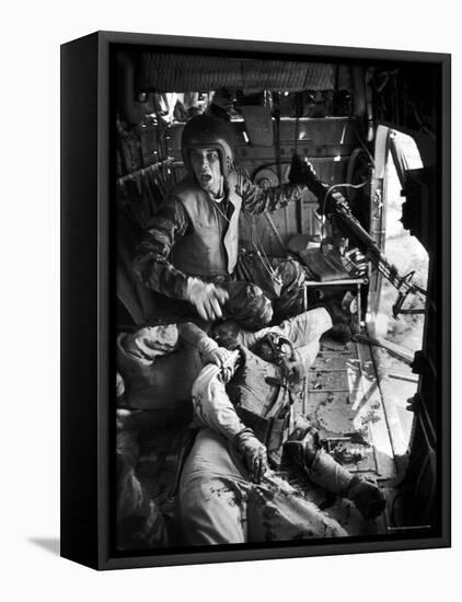 Helicopter Crew Chief James C. Farley Shouting to Crew as Wounded Comrades Lay Dying at His Feet-Larry Burrows-Framed Stretched Canvas