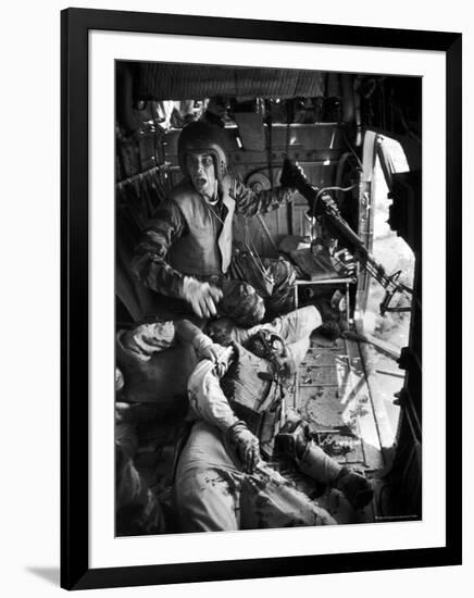 Helicopter Crew Chief James C. Farley Shouting to Crew as Wounded Comrades Lay Dying at His Feet-Larry Burrows-Framed Photographic Print