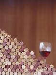 Wine Corks, Piled Up, and a Glass of Red Wine-Henrik Freek-Framed Photographic Print