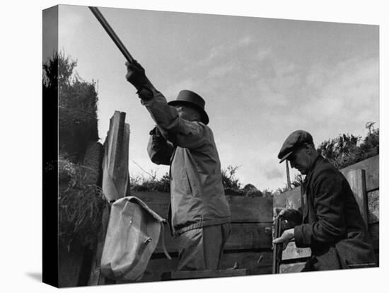 Herbert Lee Pratt Firing His Gun Toward a Grouse While the Loader Reloads Ammunition-John Phillips-Stretched Canvas
