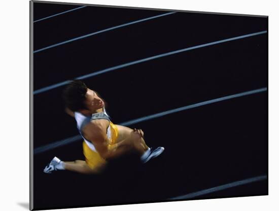 High Angle View of a Young Man Running on a Running Track-null-Mounted Photographic Print