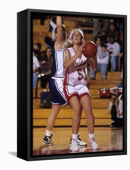 High School Girls Basketball Players in Action During a Game-null-Framed Stretched Canvas