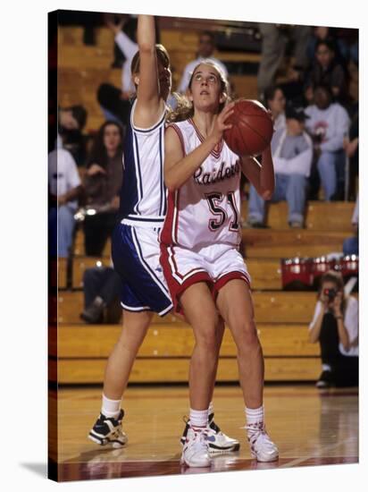 High School Girls Basketball Players in Action During a Game-null-Stretched Canvas