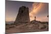 Hiker Admires Sunset from the Stone Tower Overlooking the Bay, Porto Giunco, Villasimius-Roberto Moiola-Mounted Photographic Print