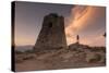 Hiker Admires Sunset from the Stone Tower Overlooking the Bay, Porto Giunco, Villasimius-Roberto Moiola-Stretched Canvas