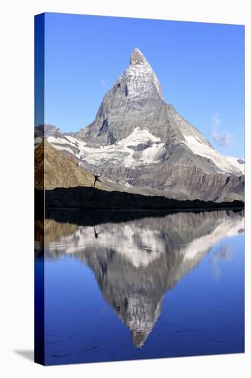 Hiker Admiring the Matterhorn Reflected in Lake Stellisee, Swiss Alps-Roberto Moiola-Stretched Canvas