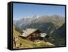 Hiker and Dog on Trail in Front of Traditional Slate Roofed House, Valais, Switzerland-Christian Kober-Framed Stretched Canvas