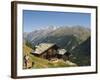Hiker and Dog on Trail in Front of Traditional Slate Roofed House, Valais, Switzerland-Christian Kober-Framed Photographic Print