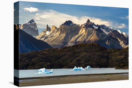 Hiker And Icebergs In Lago Grey In The Torres Del Paine National Park, Patagonia, Chile-Jay Goodrich-Stretched Canvas