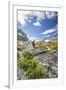 Hiker crossing a stream Engadine Canton of Grisons Switzerland Europe-ClickAlps-Framed Photographic Print