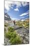 Hiker crossing a stream Engadine Canton of Grisons Switzerland Europe-ClickAlps-Mounted Photographic Print