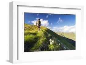 Hiker on steep ridge on the ascent towards Monte Azzarini, San Marco Pass, Albaredo Valley-Roberto Moiola-Framed Photographic Print