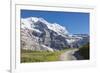 Hiker on the path between green meadows and snowy peaks, Wengernalp, Wengen, Bernese Oberland, Cant-Roberto Moiola-Framed Photographic Print