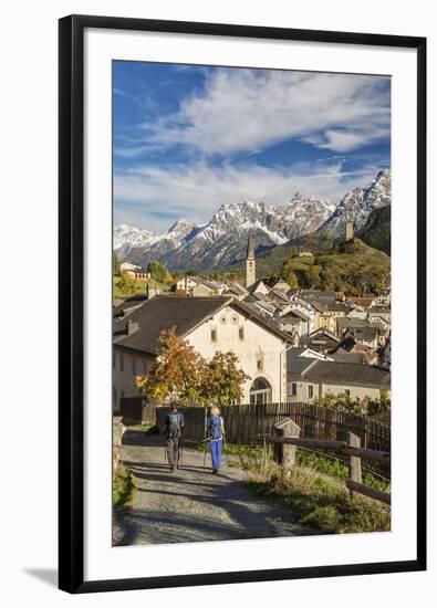 Hikers admire Ardez village surrounded by woods and snowy peaks Lower Engadine Canton of Switzerlan-ClickAlps-Framed Premium Photographic Print