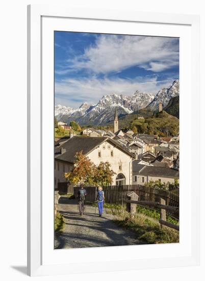 Hikers admire Ardez village surrounded by woods and snowy peaks Lower Engadine Canton of Switzerlan-ClickAlps-Framed Photographic Print