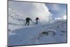 Hikers proceed in the snowy valley of Alpe Fora, Malenco Valley, Province of Sondrio, Valtellina, L-Roberto Moiola-Mounted Photographic Print