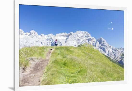 Hikers proceed on the path to the rocky peaks, Doss Del Sabion, Pinzolo, Brenta Dolomites, Trentino-Roberto Moiola-Framed Photographic Print