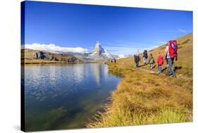 Hikers Walking on the Path Beside the Stellisee with the Matterhorn Reflected-Roberto Moiola-Stretched Canvas