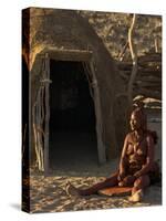 Himba Woman Grinding Rock into Powder, Purros Village, Kaokoland, Namibia-Kim Walker-Stretched Canvas