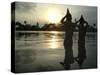 Hindu Devotees Offer Prayers to the Sun God at Sunset-null-Stretched Canvas