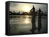 Hindu Devotees Offer Prayers to the Sun God at Sunset-null-Framed Stretched Canvas