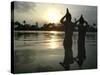 Hindu Devotees Offer Prayers to the Sun God at Sunset-null-Stretched Canvas