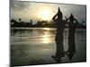 Hindu Devotees Offer Prayers to the Sun God at Sunset-null-Mounted Premium Photographic Print