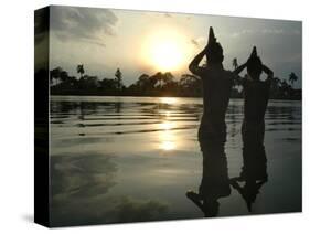 Hindu Devotees Offer Prayers to the Sun God at Sunset-null-Stretched Canvas