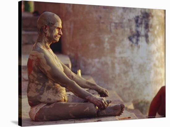Hindu Pilgrim Meditating, Sitting Cross-Legged on the Ghats, Varanasi, Uttar Pradesh State, India-John Henry Claude Wilson-Stretched Canvas
