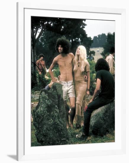 Hippie Couple Posed Together Arm in Arm with Others Around Them, During Woodstock Music/Art Fair-John Dominis-Framed Photographic Print