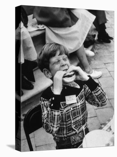 Hollywood Child Timmy Garry at Children's party Dressed in Cowboy Outfit eating a Hamburger-J^ R^ Eyerman-Stretched Canvas