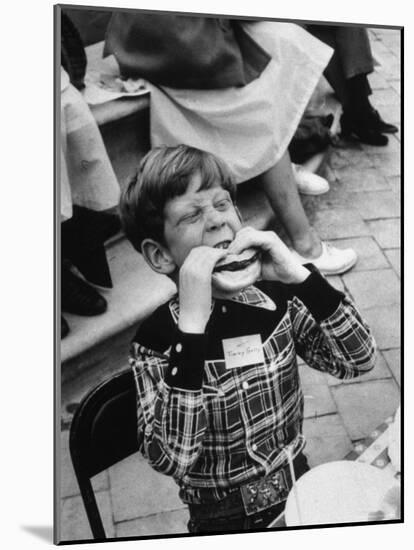 Hollywood Child Timmy Garry at Children's party Dressed in Cowboy Outfit eating a Hamburger-J^ R^ Eyerman-Mounted Photographic Print