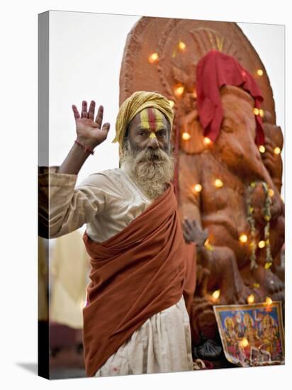 Holy Man in Front of a Ganesh Statue Draped in Fairy Lights at the Hindu Festival of Shivaratri-Don Smith-Stretched Canvas