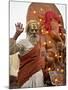 Holy Man in Front of a Ganesh Statue Draped in Fairy Lights at the Hindu Festival of Shivaratri-Don Smith-Mounted Photographic Print